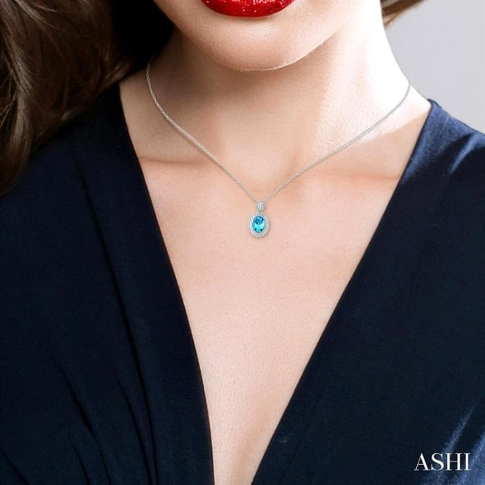 8X6 MM Oval Cut Blue Topaz and 1/20 Ctw Round Cut Diamond Semi-Precious Pendant With Chain in Sterling Silver