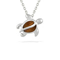 Small honu pendant with koa wood inlay, featuring a polished sea turtle design natural wood grain. Item No. 770261