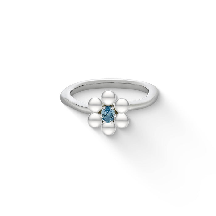 A blue topaz center surrounded by white freshwater pearls make a delicate sterling silver pearl flower ring. Item No. 44496